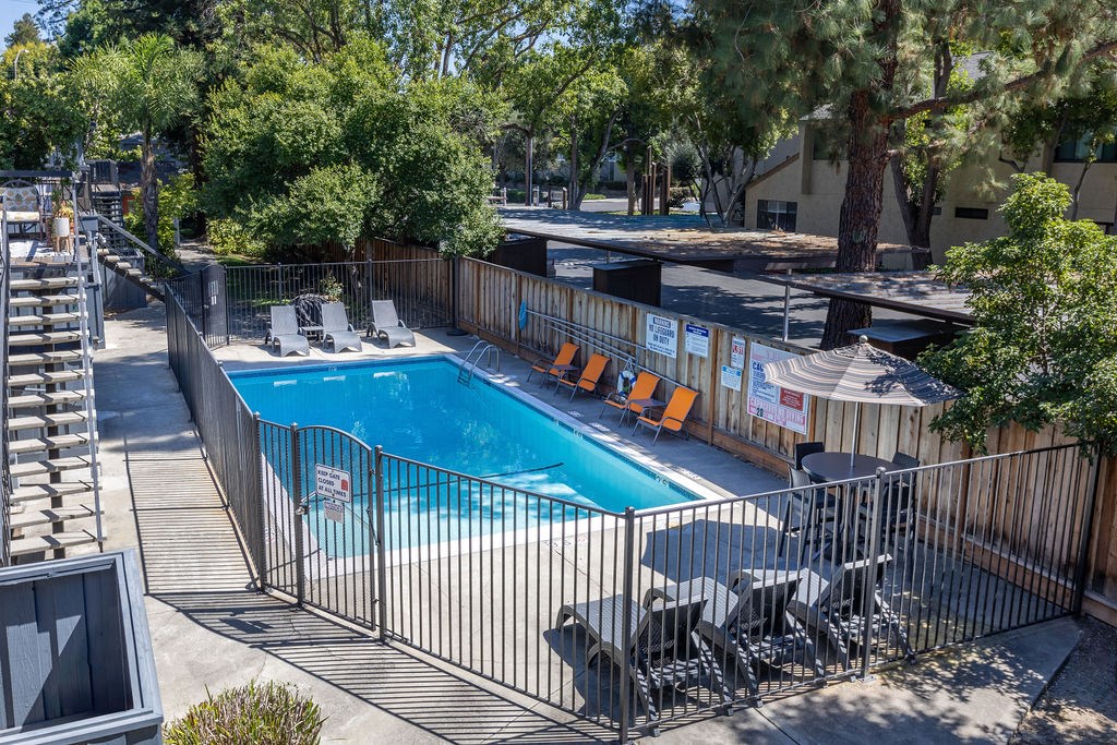 a swimming pool at a resort with a fence around it