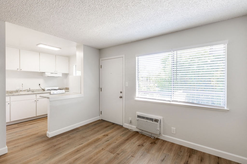 an empty kitchen and living room with a large window
