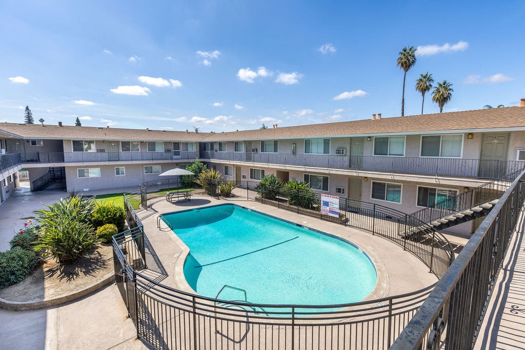 a swimming pool and a building with a resort style pool