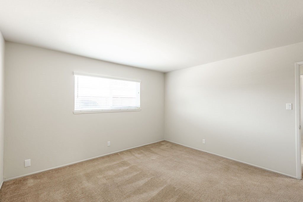 a room with carpet and a window