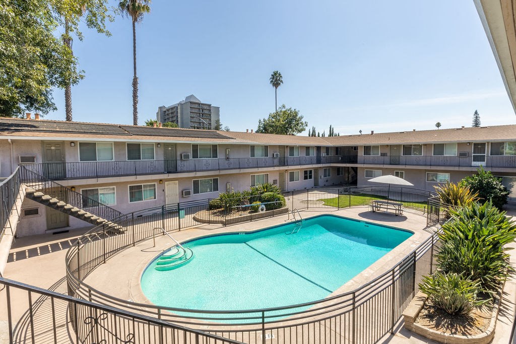 a view of a swimming pool and a building with trees