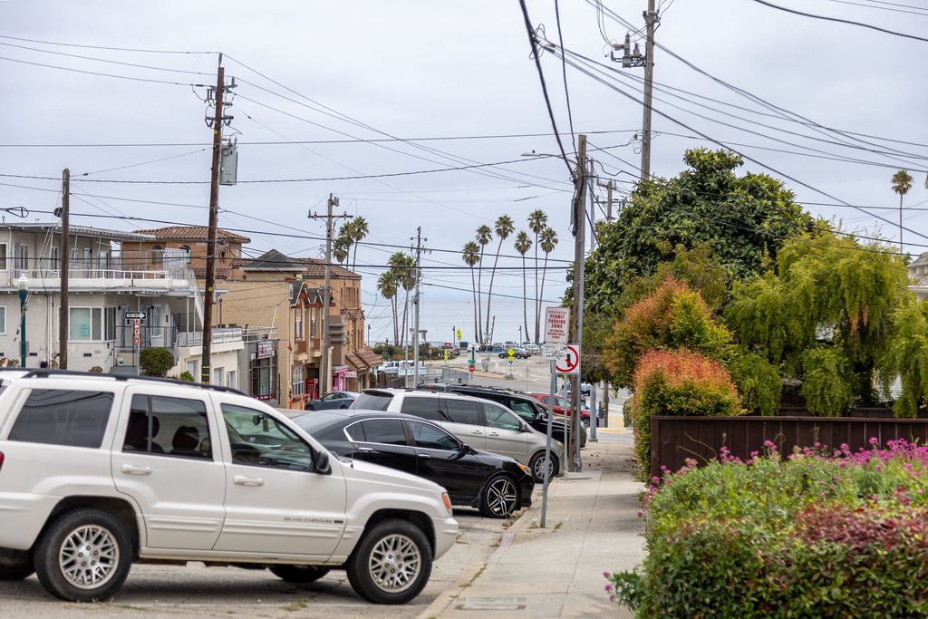 a row of cars parked on the side of a street