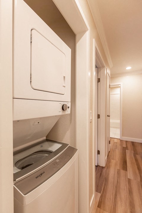 A white dishwasher is built into a kitchen cabinet.