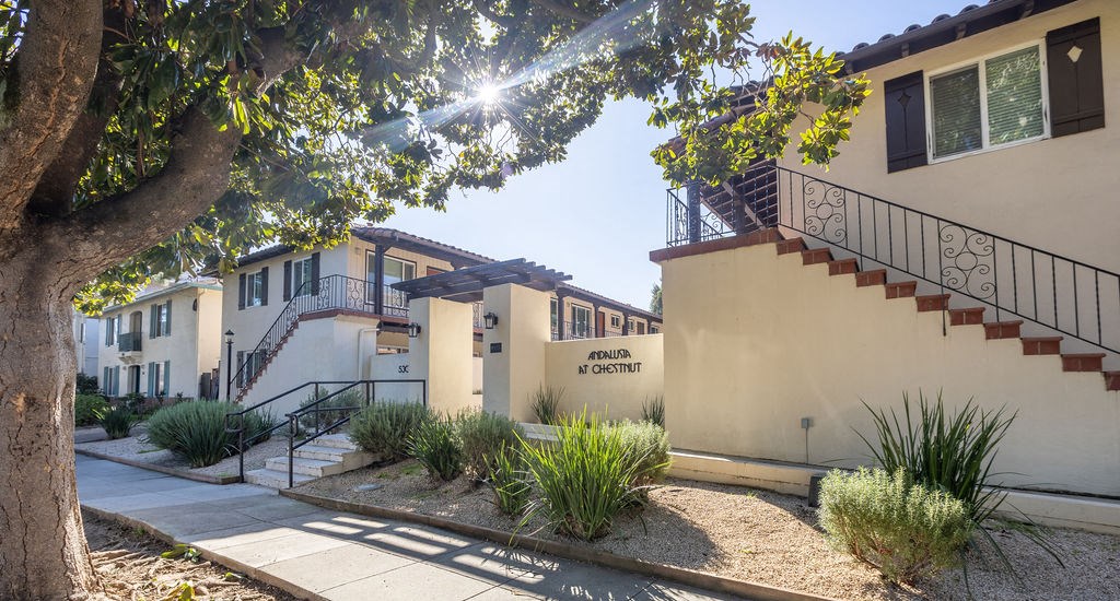 A sunny day at the residential area with houses and trees.