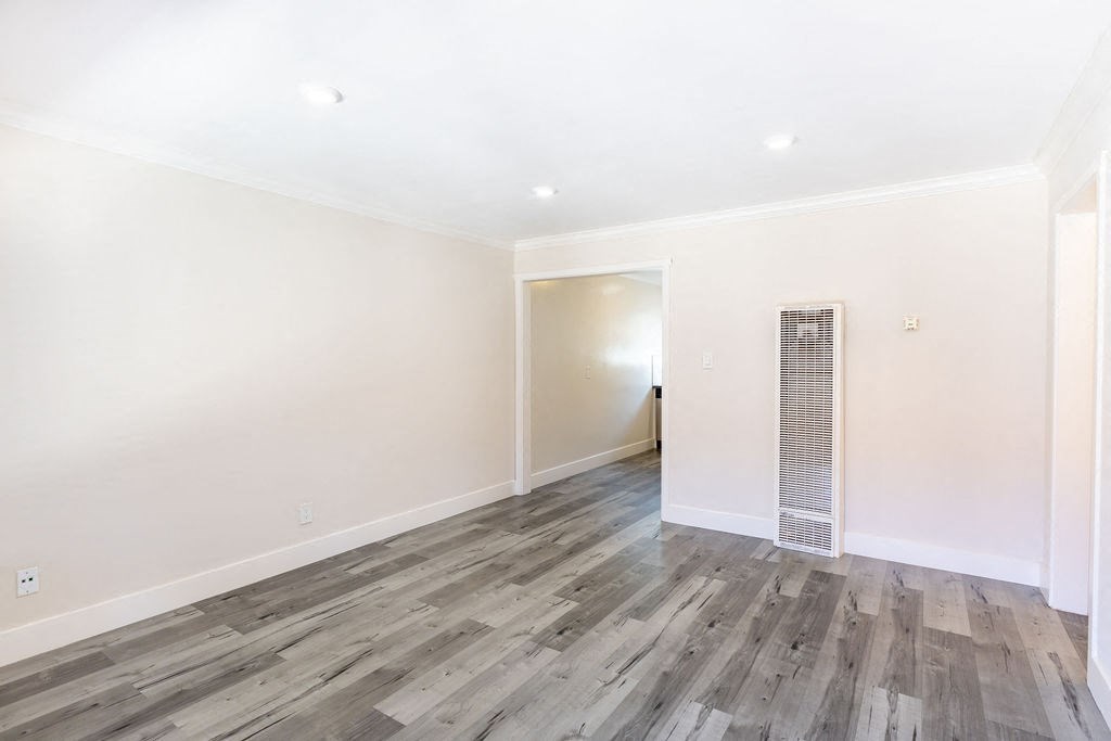 A room with a wooden floor and white walls.