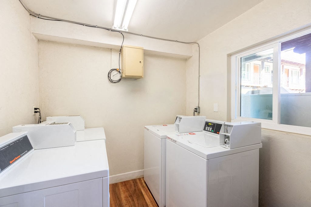 A white washing machine and dryer in a small room.