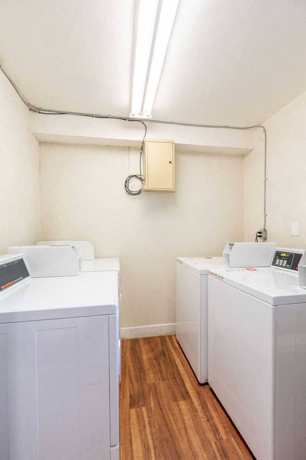 A white washing machine and dryer in a small room.