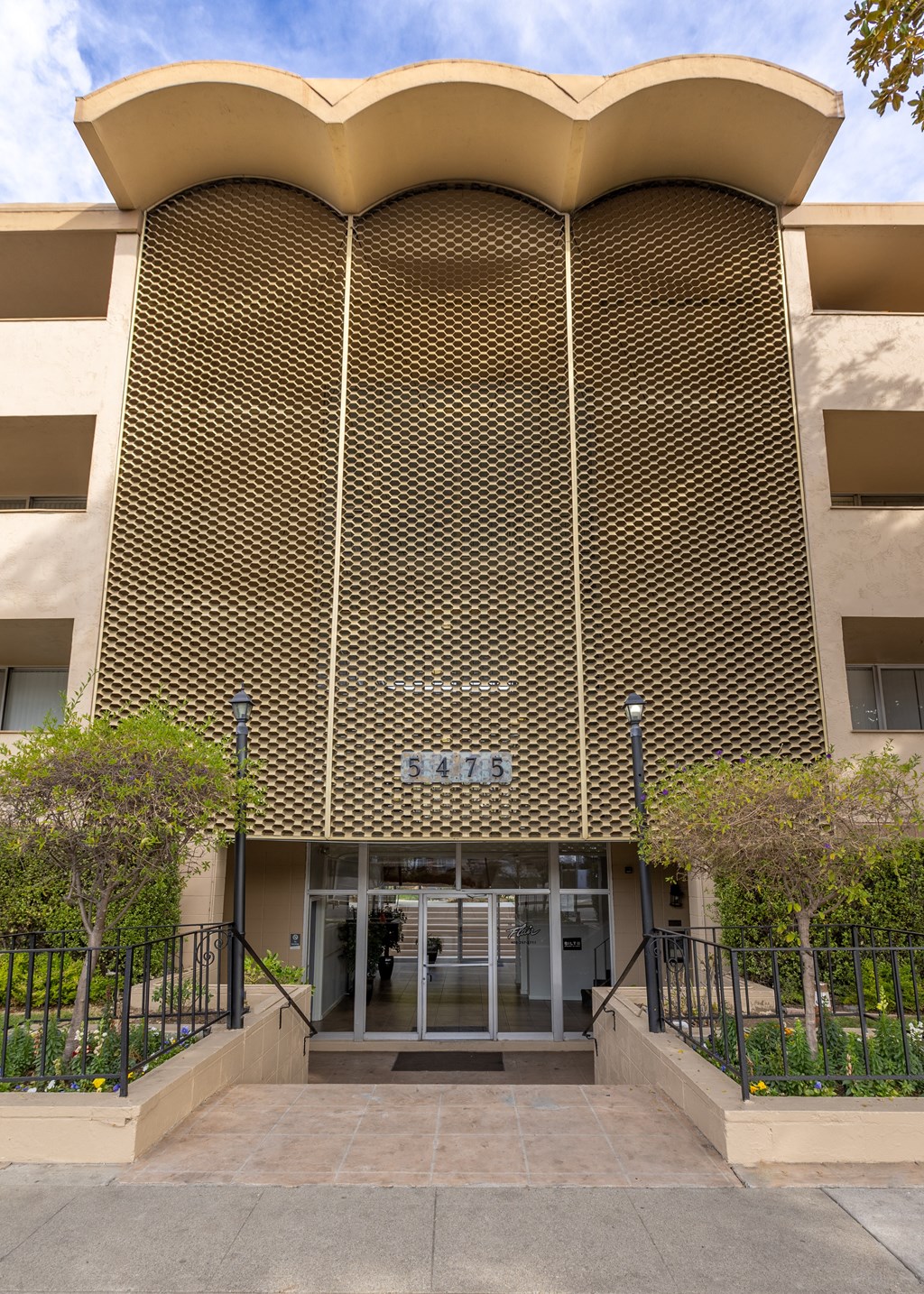 A building with a unique curved facade and a number 5475 on it.