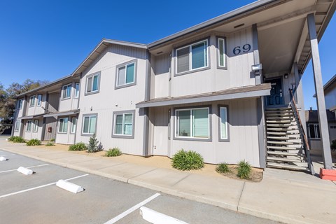 Apartment building number 69 with a parking lot in front.