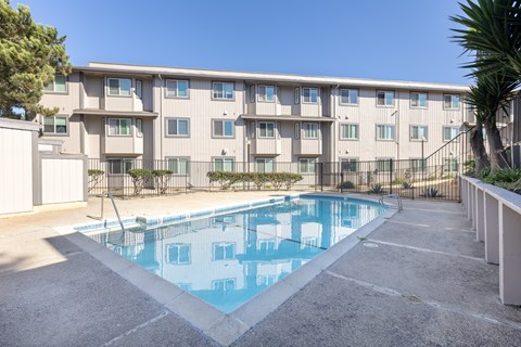 A swimming pool in front of a building.