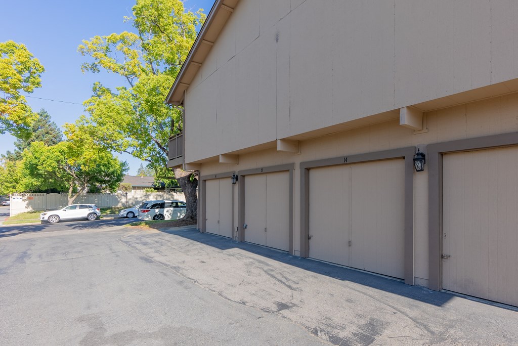 a building with white garage doors and a parking lot