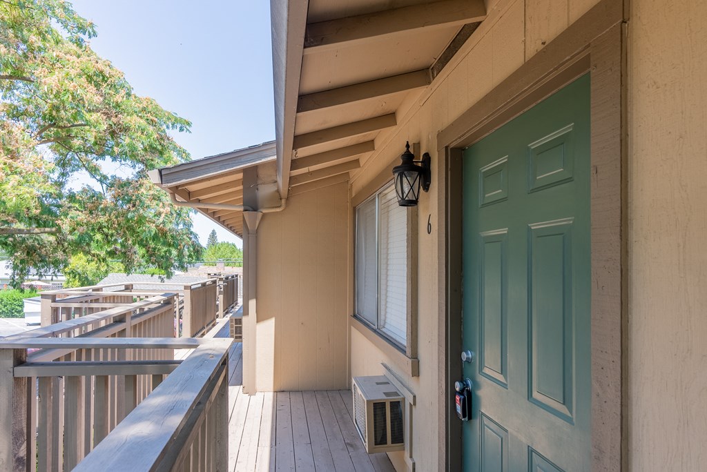 the front door of a house with a balcony