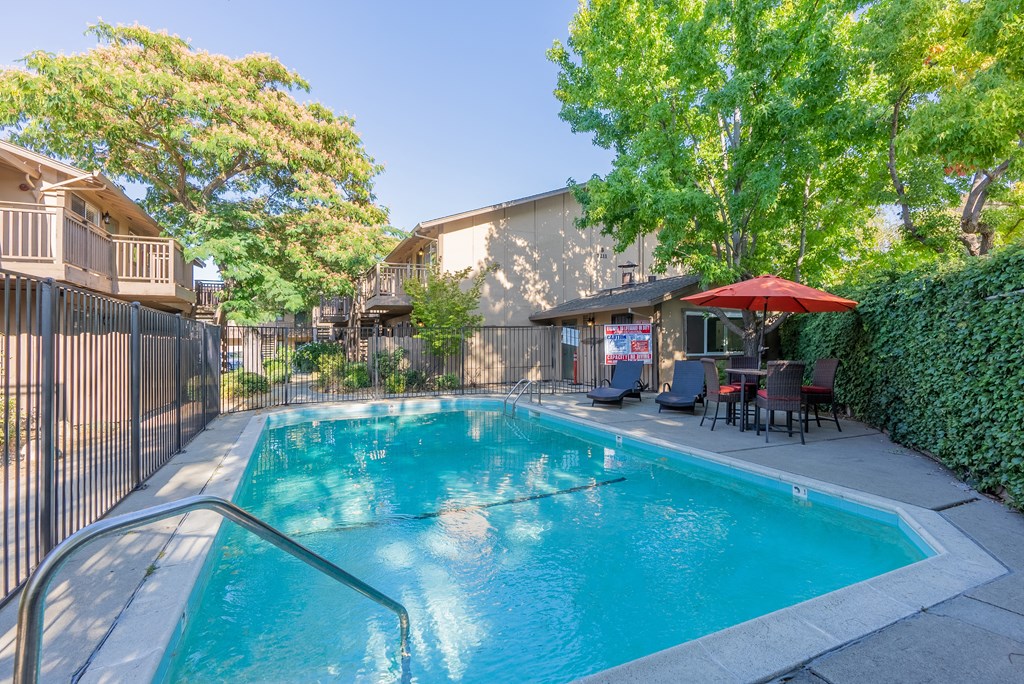 our apartments have a swimming pool and a patio with chairs