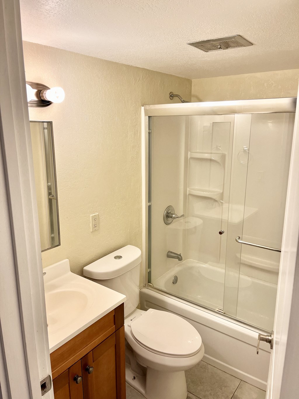 a bathroom with a toilet sink and shower