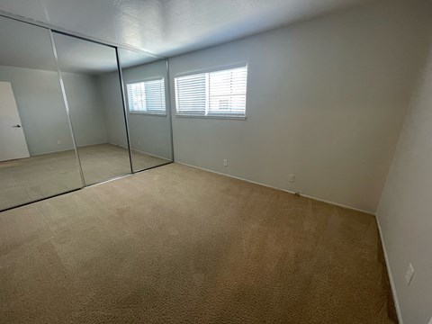 A room with a carpeted floor and a glass partition wall.