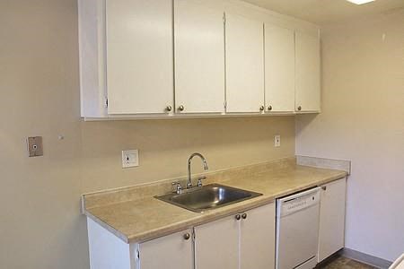 a kitchen with a sink and white cabinets