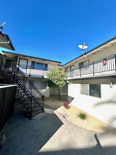 A sunny day at a residential complex with a clear blue sky.