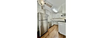 a kitchen with stainless steel appliances and white cabinets