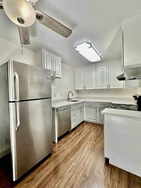 a kitchen with stainless steel appliances and white cabinets