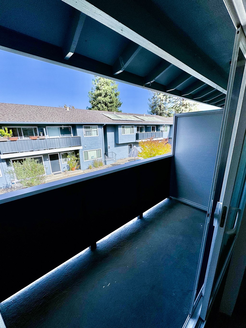 a balcony with a view of an apartment building