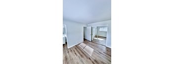 a living room with a hard wood floor and a sliding glass door