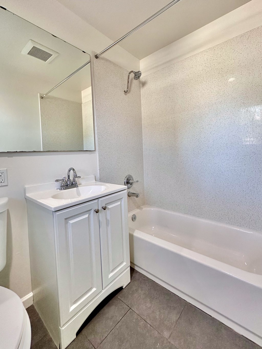a bathroom with a sink and a tub and a mirror