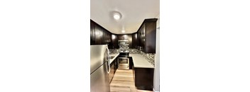 a kitchen with black cabinets and a white counter top
