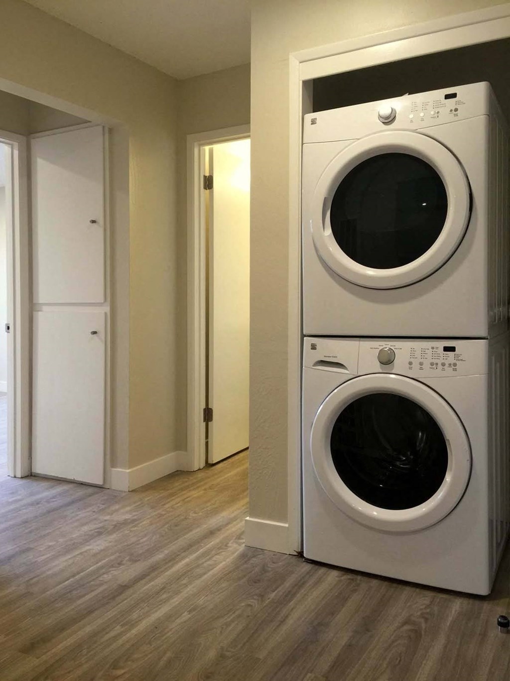 a front load washer and dryer sit next to each other in a laundry room