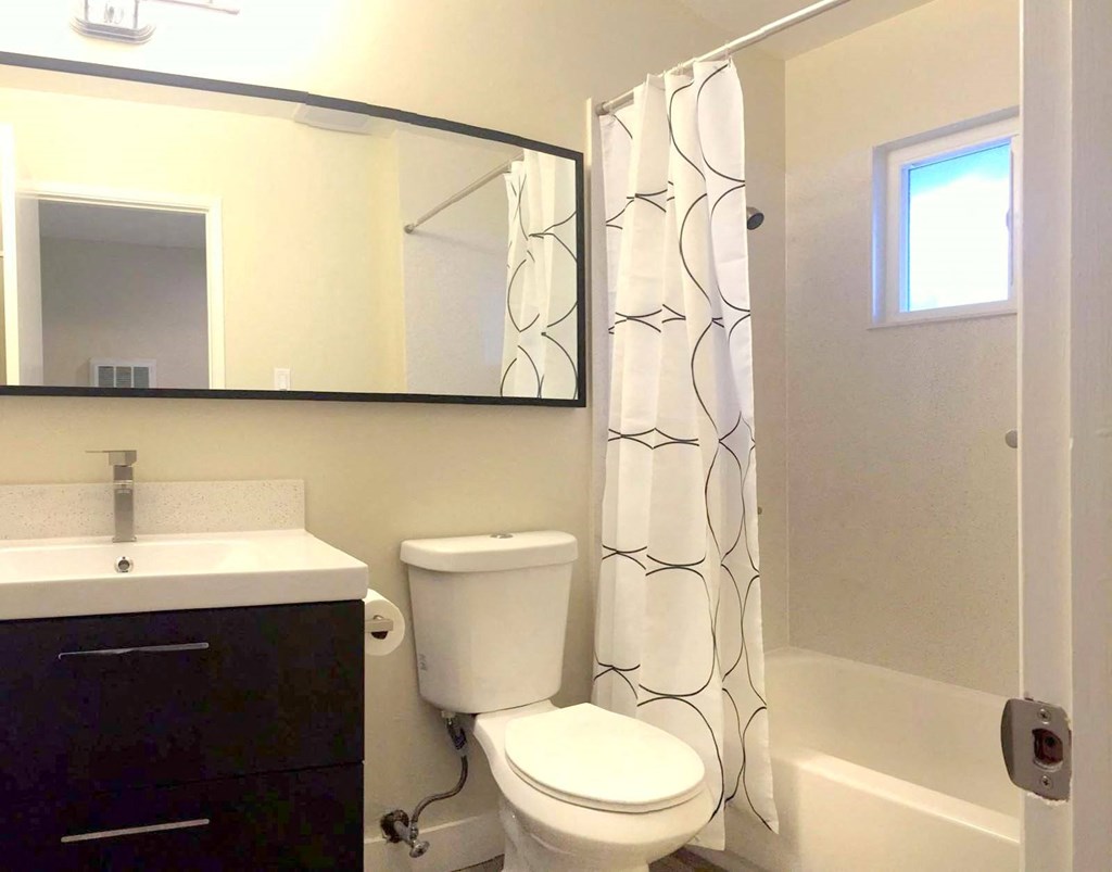 a bathroom with a sink toilet and bathtub