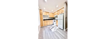 an empty kitchen with wooden cabinets and stainless steel appliances