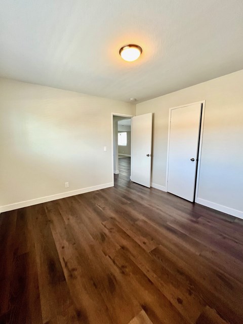 A room with wooden floors and white walls.