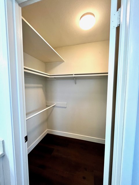 A small, empty room with a single light fixture on the ceiling.