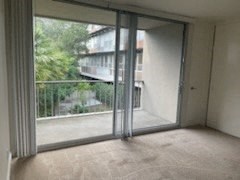 an empty living room with the balcony