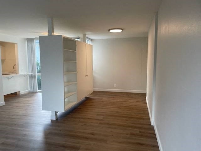 an empty living room with a white cabinet in it