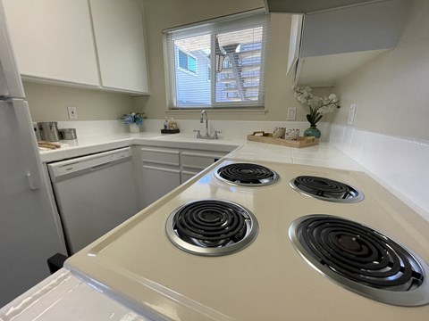 A kitchen with a white stove top oven.