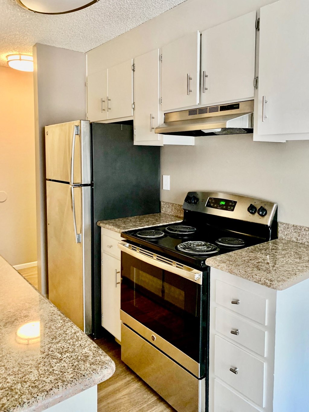 a kitchen with a stove and a refrigerator