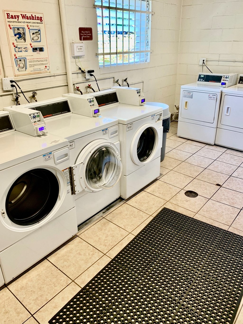 a washer and dryer in a laundry room with other washing machines