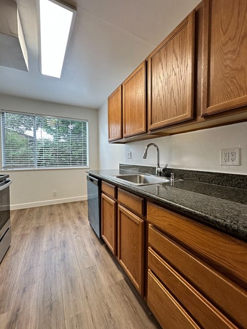 the preserve at ballantyne commons apartment kitchen with sink and wood cabinets