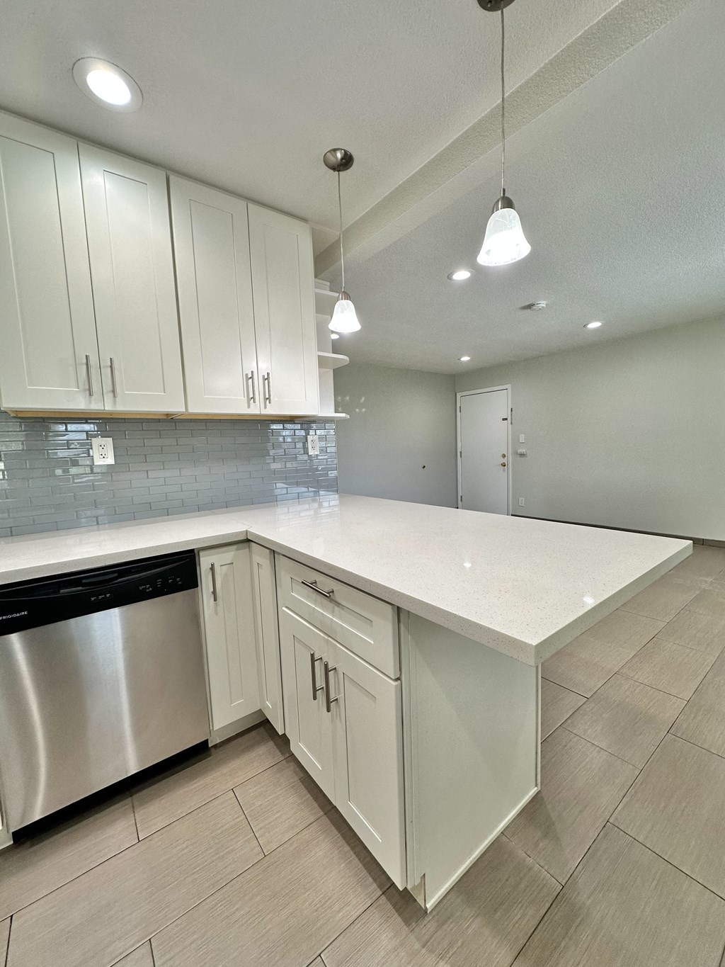 a kitchen with white cabinets and a white counter top