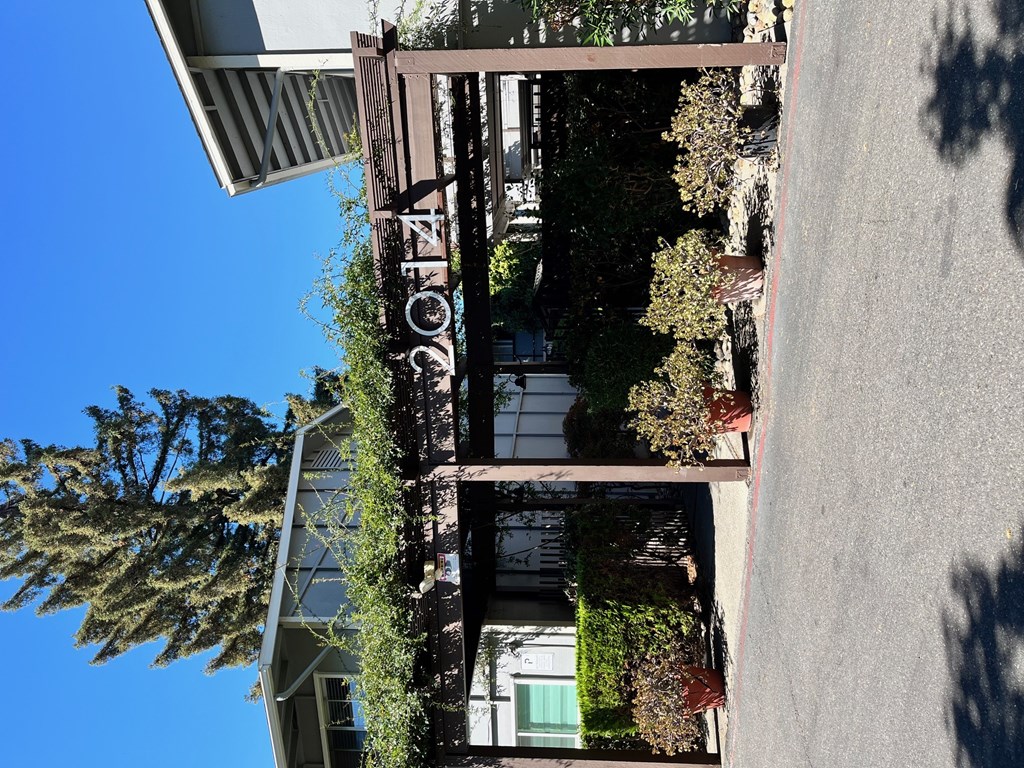 A sign that says "Eco" is hanging from a building.