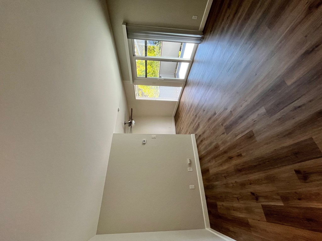 A wooden staircase with a skylight above it.