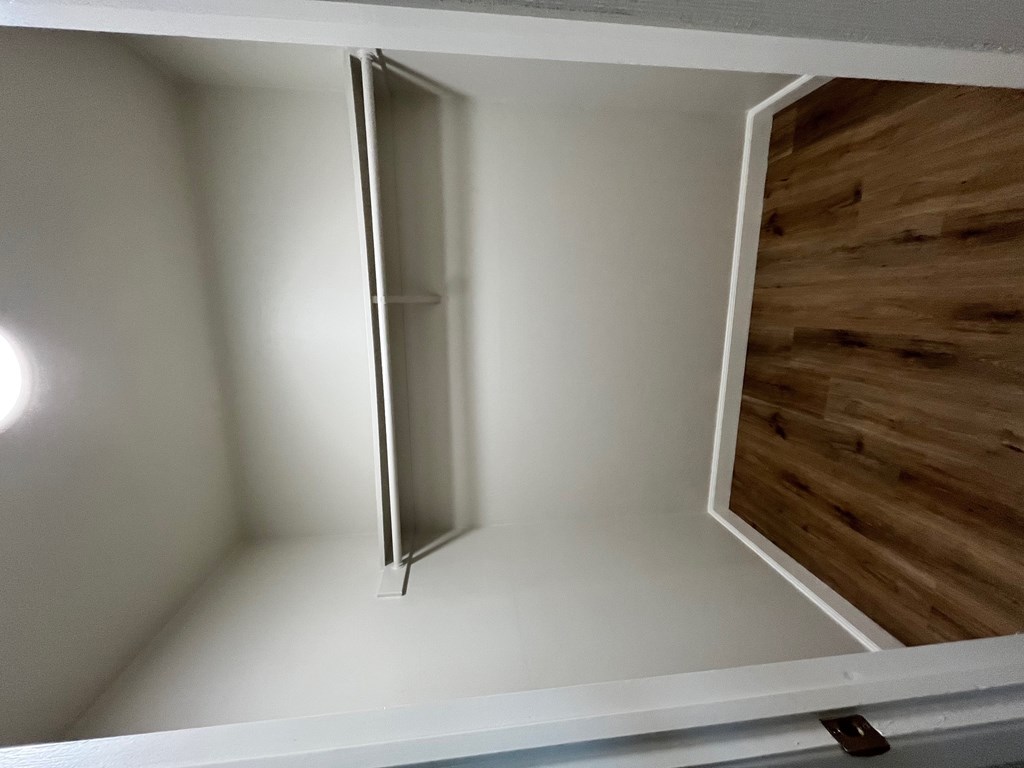 A white door is open in a room.