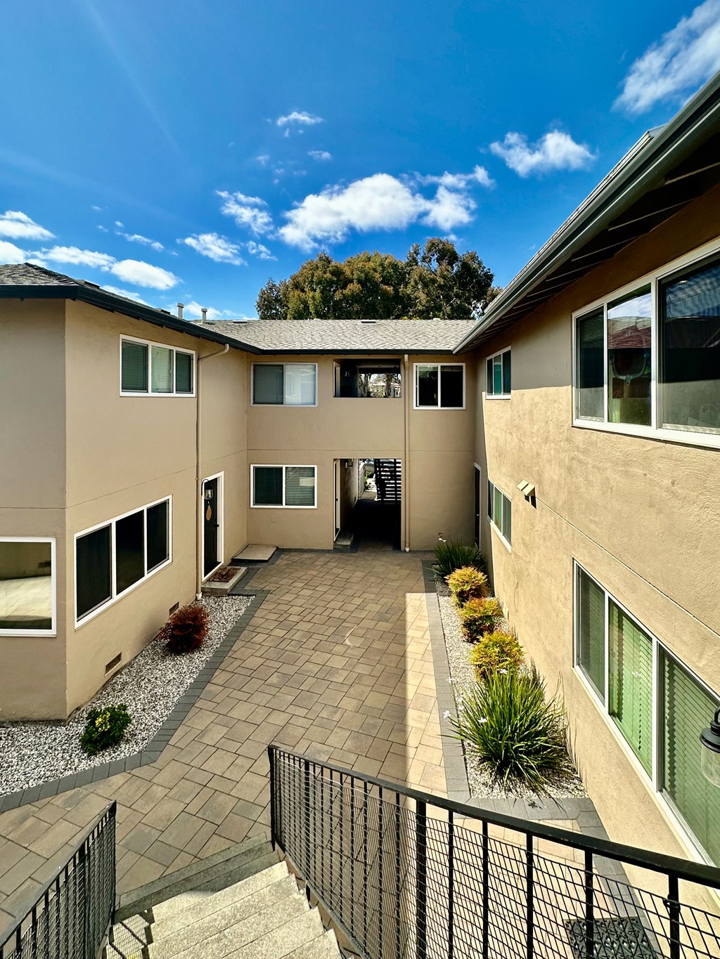 a view of the courtyard of a building with a blue sky