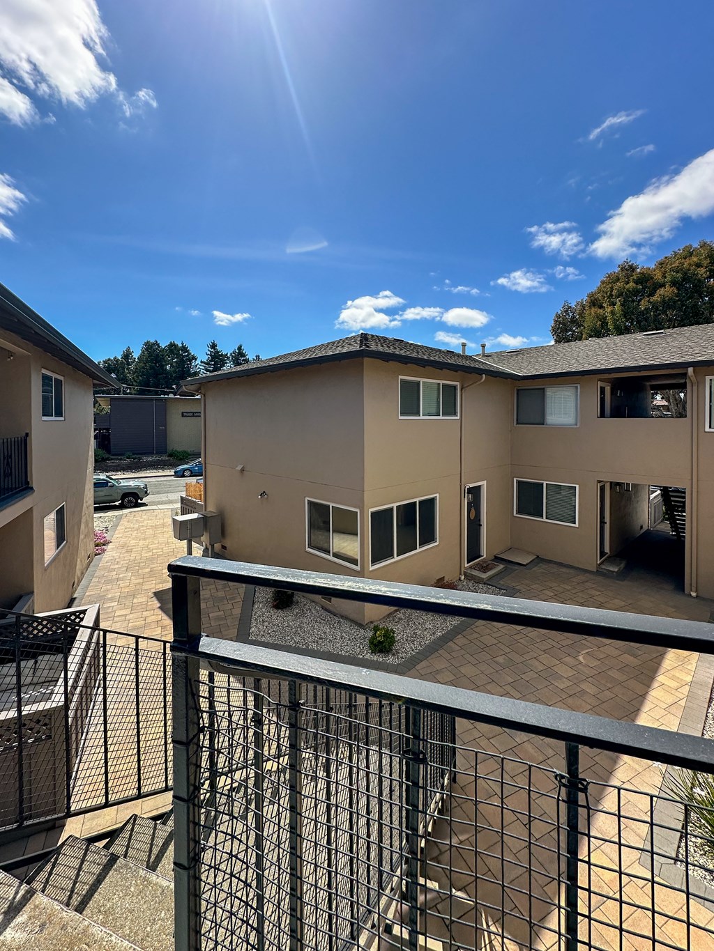 a view of a building from a balcony with a blue sky