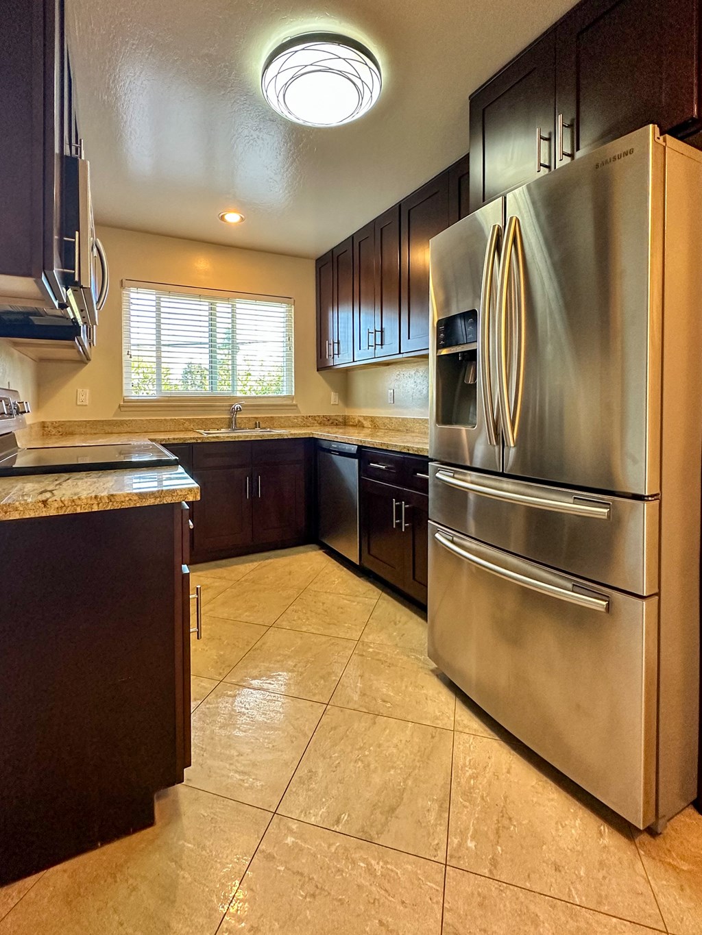 a kitchen with stainless steel appliances and black cabinets
