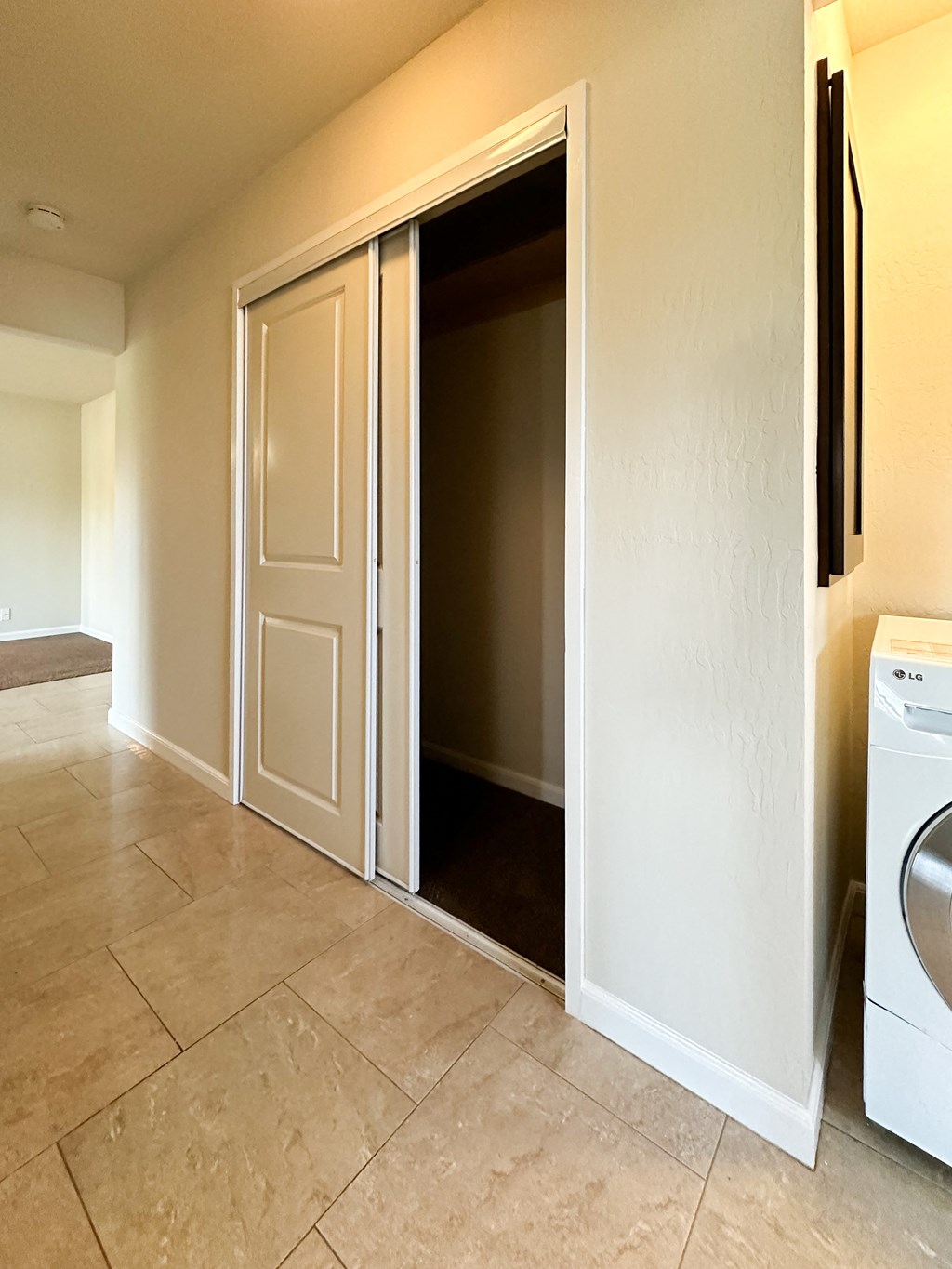 an empty laundry room with a washer and dryer