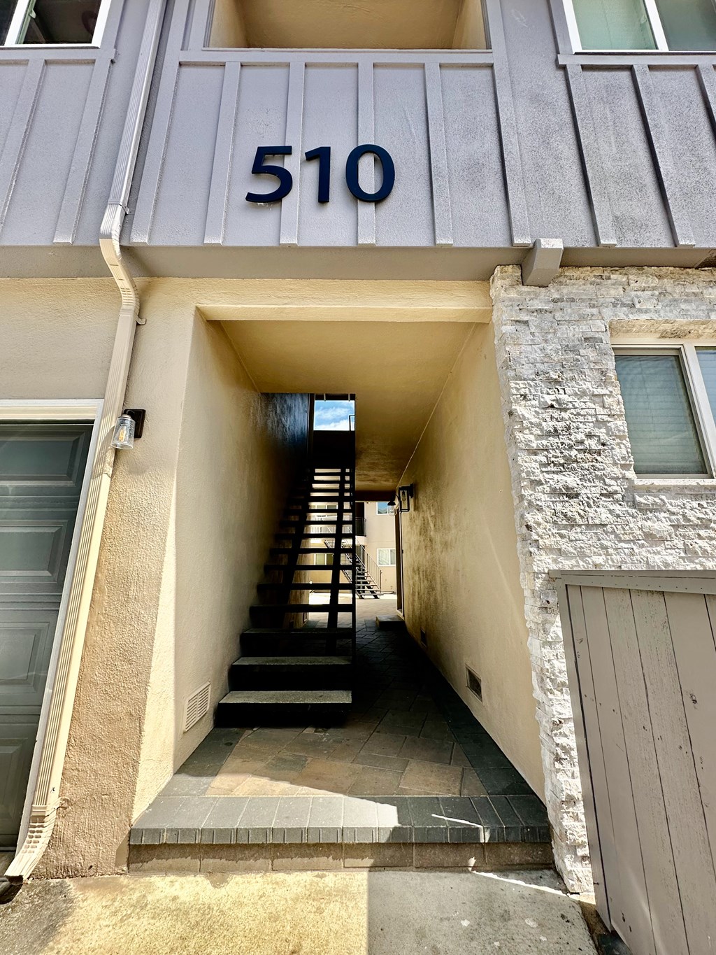 the front of a building with stairs and a number
