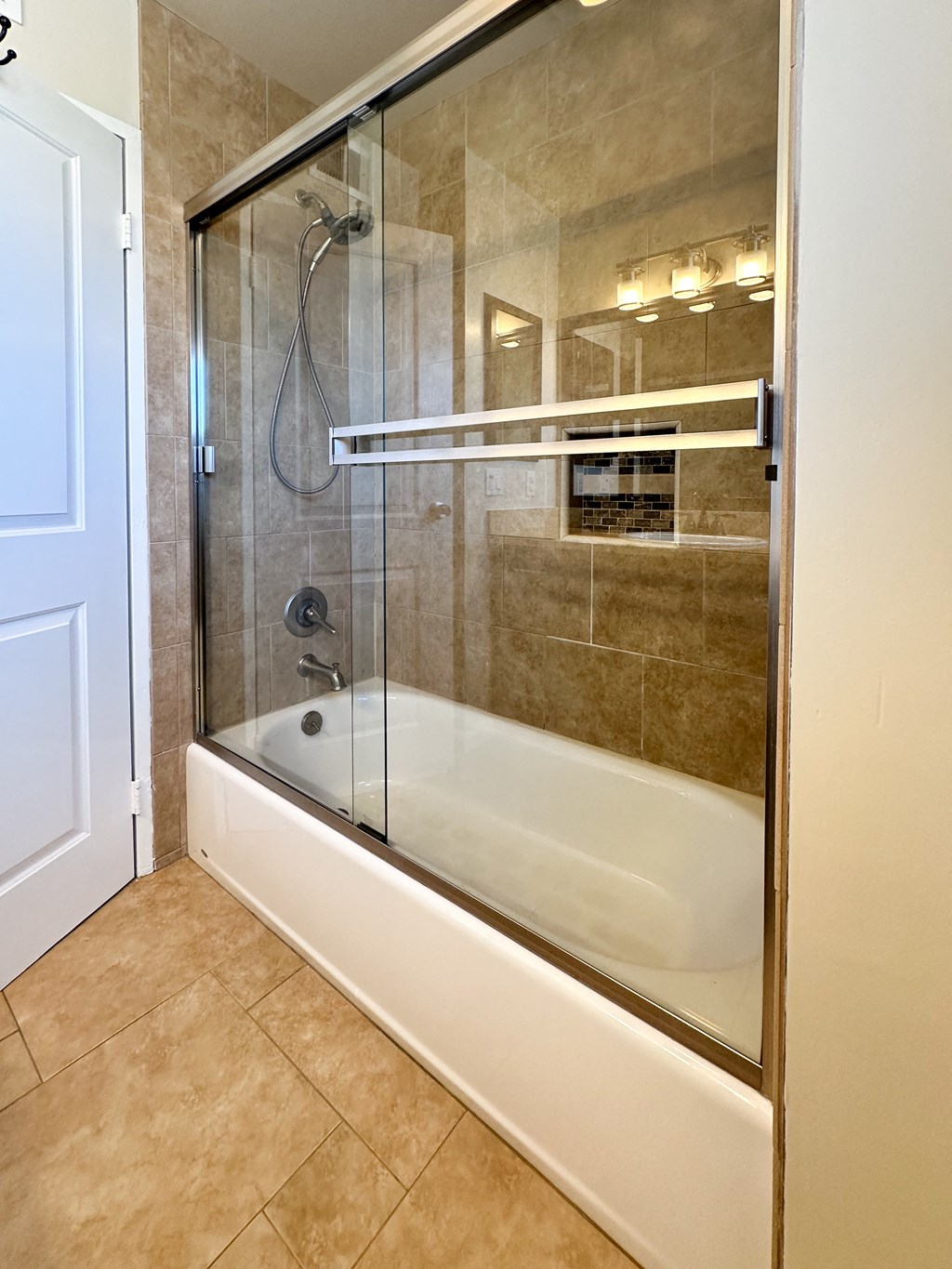 the master bathroom has a large shower and a soaking tub