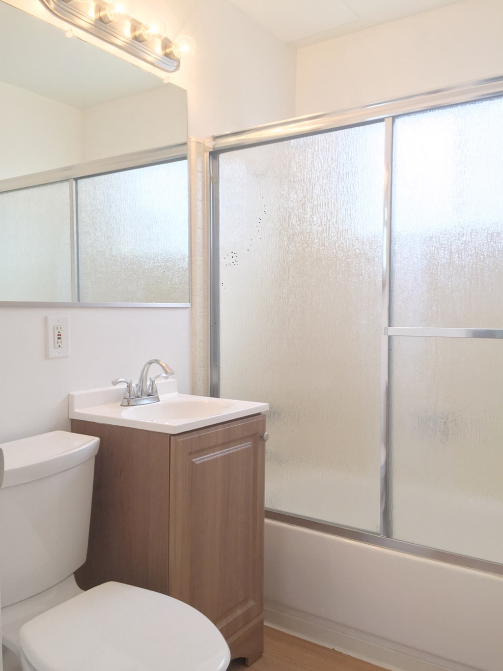 an empty bathroom with a toilet sink and shower