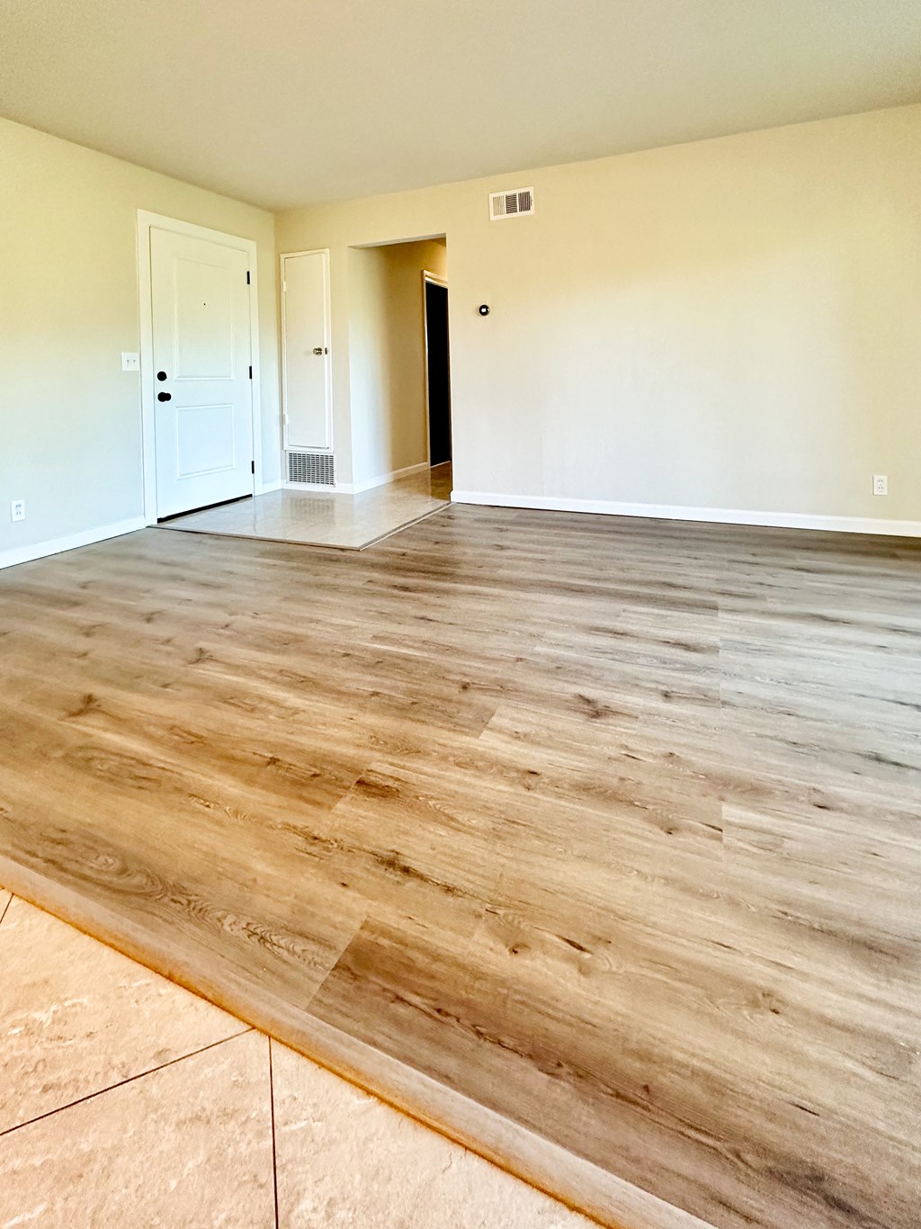 the living room and dining room of a new home with wood flooring